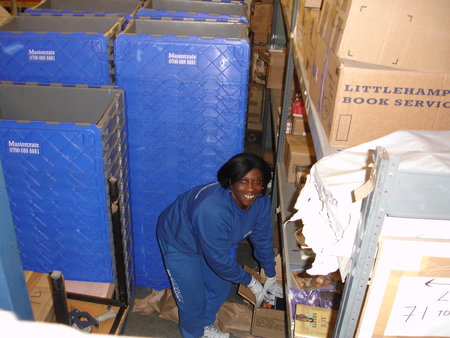 The lovely Wilma packs up for the huge warehouse move of 2009. We relocated to bigger premises and carefully wrapped nearly a quarter of a million books! / {Location}: Old warehouse 5 Thomas Road Poplar E14\\n\\n03/01/2008 13:23